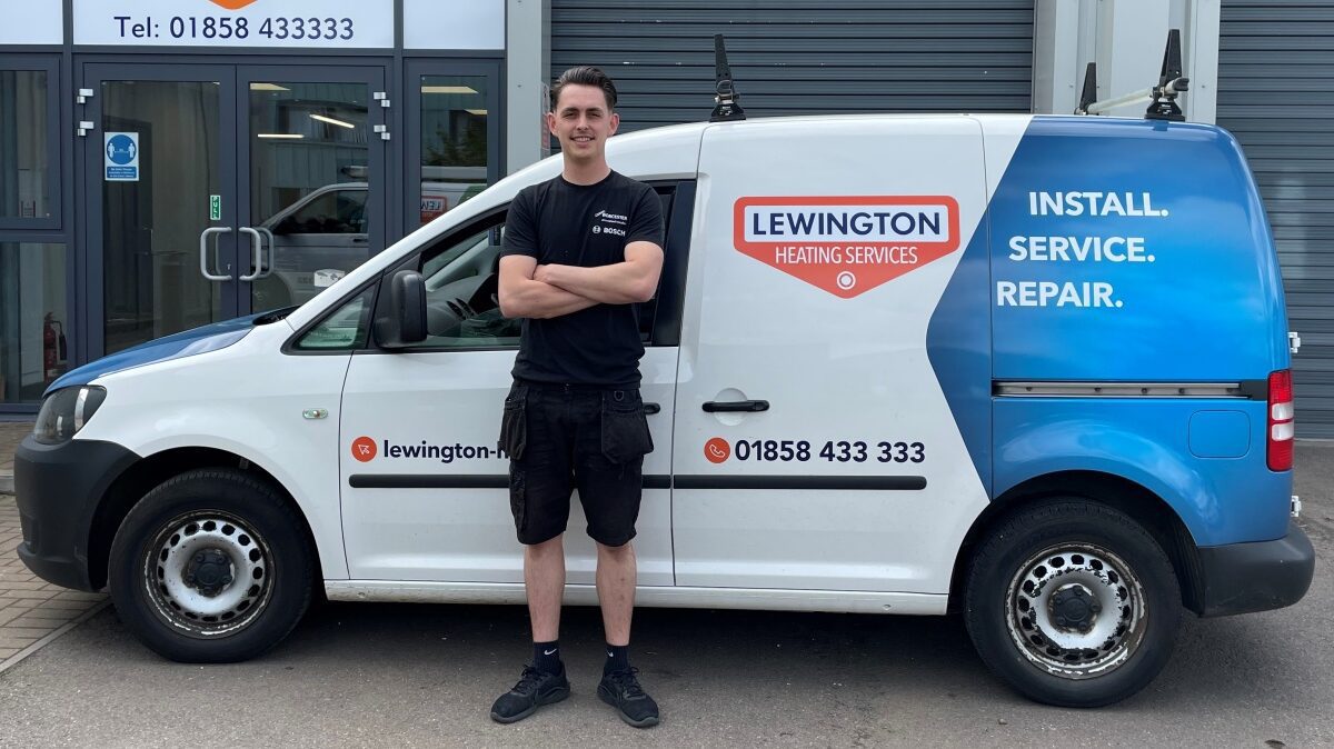 Lewington Heating technician standing beside a branded service van, ready for gas and oil heating installation, service, and repair work.